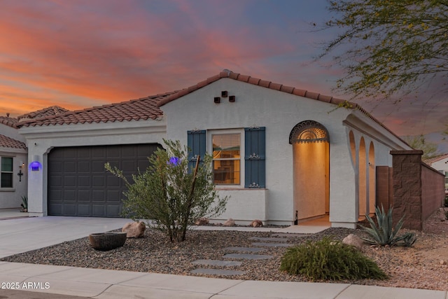 11658 E Chevelon Trl, Gold Canyon, AZ 85118 - mediterranean / spanish-style house with a garage, concrete driveway, a tile roof, and stucco siding