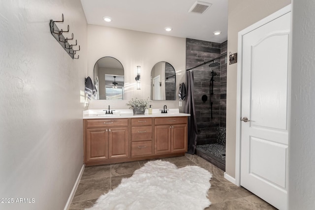 11658 E Chevelon Trl, Gold Canyon, AZ 85118 - bathroom with a shower stall, double vanity, baseboards, recessed lighting, and a ceiling fan
