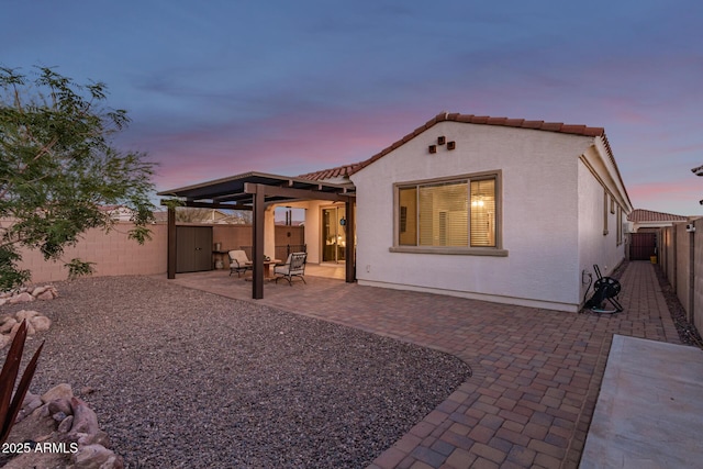 11658 E Chevelon Trl, Gold Canyon, AZ 85118 - back of property featuring a fenced backyard, stucco siding, a patio area, a tiled roof, and a gate