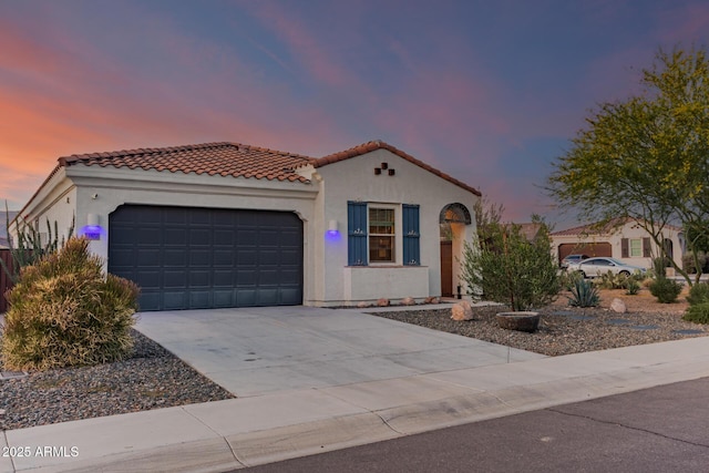 11658 E Chevelon Trl, Gold Canyon, AZ 85118 - mediterranean / spanish house featuring a garage, concrete driveway, stucco siding, and a tiled roof