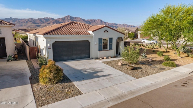 11658 E Chevelon Trl, Gold Canyon, AZ 85118 - mediterranean / spanish home with driveway, a mountain view, a garage, a tiled roof, and stucco siding