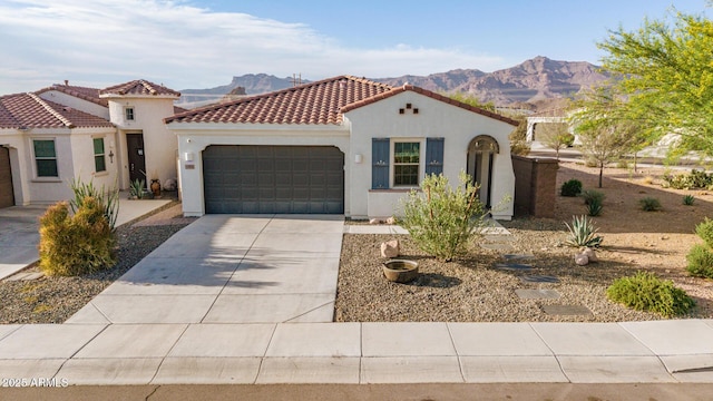 11658 E Chevelon Trl, Gold Canyon, AZ 85118 - mediterranean / spanish-style home featuring a mountain view, a garage, stucco siding, concrete driveway, and a tiled roof
