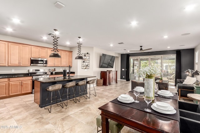 11658 E Chevelon Trl, Gold Canyon, AZ 85118 - kitchen with stainless steel appliances, light brown cabinets, ceiling fan, a breakfast bar, and recessed lighting