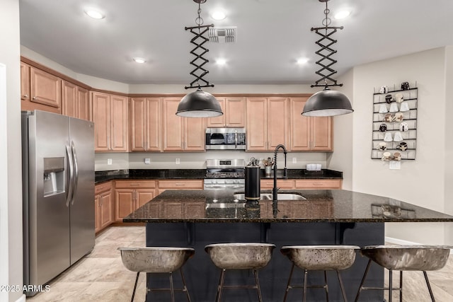 11658 E Chevelon Trl, Gold Canyon, AZ 85118 - kitchen featuring appliances with stainless steel finishes, light brown cabinets, a sink, an island with sink, and dark stone counters