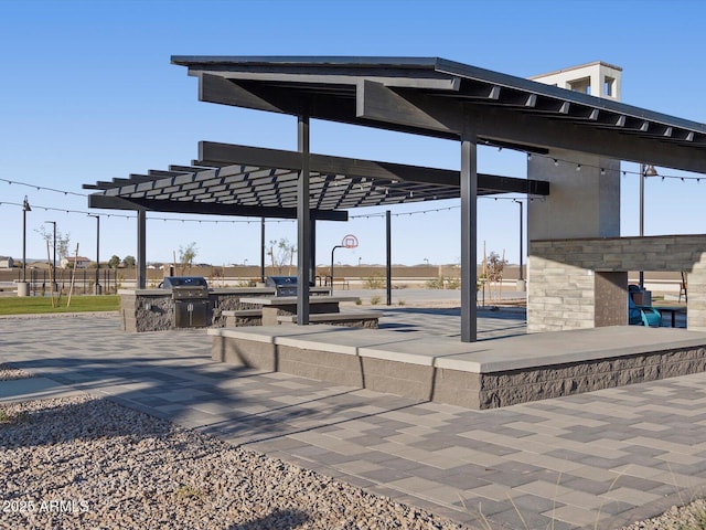 view of property's community with an outdoor kitchen and a pergola