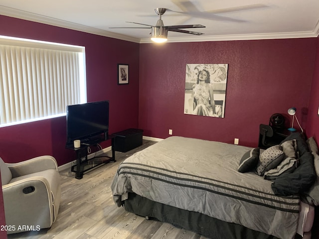 bedroom featuring ceiling fan, ornamental molding, and hardwood / wood-style floors