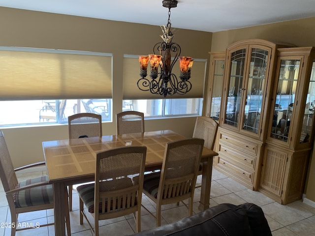 dining room featuring light tile patterned floors and a notable chandelier