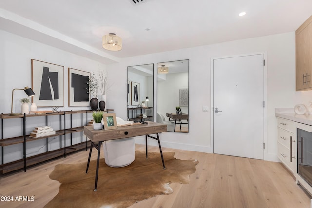 office with light wood-type flooring