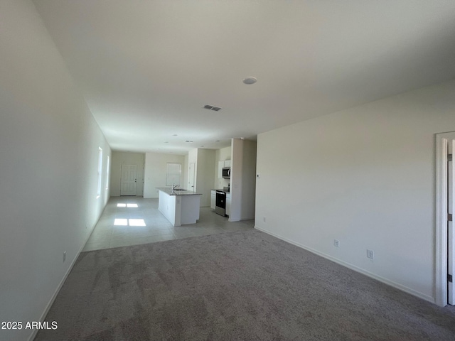 unfurnished living room with light tile patterned floors