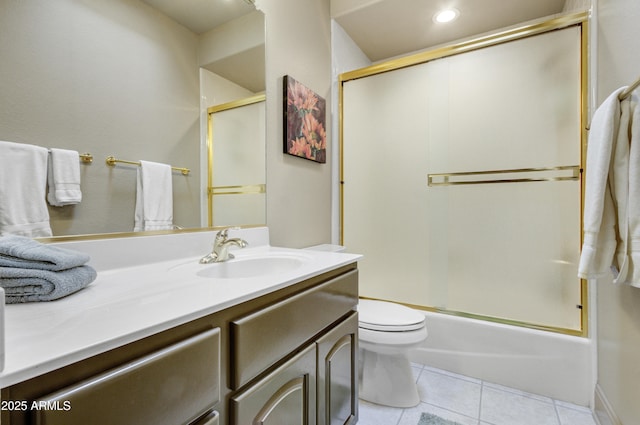 full bathroom featuring tile patterned floors, toilet, vanity, and combined bath / shower with glass door