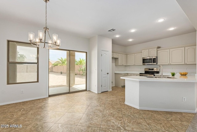 kitchen featuring pendant lighting, stainless steel appliances, an inviting chandelier, sink, and cream cabinetry