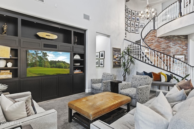 3770 E Ringtail Way, Phoenix, AZ 85050 - carpeted living area featuring stairs, a towering ceiling, built in features, and a chandelier