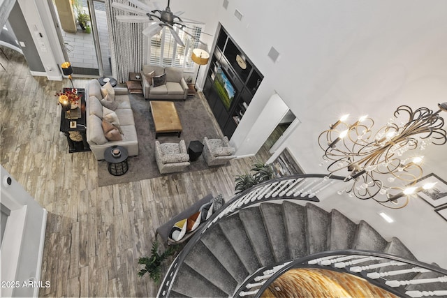 3770 E Ringtail Way, Phoenix, AZ 85050 - stairs with wood finished floors, a chandelier, a towering ceiling, and ceiling fan