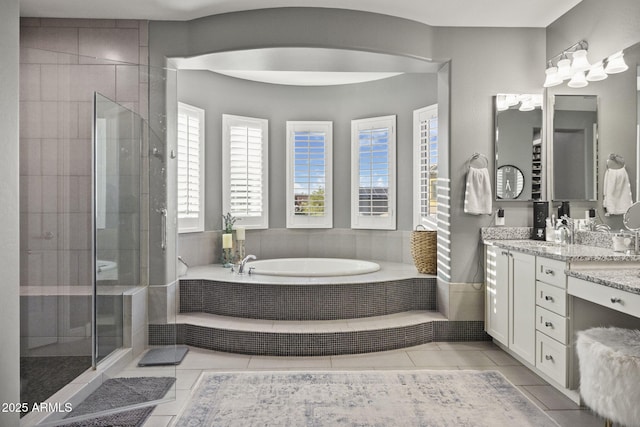 3770 E Ringtail Way, Phoenix, AZ 85050 - bathroom featuring vanity, a garden tub, a stall shower, and tile patterned flooring