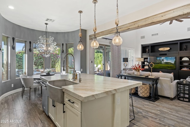 3770 E Ringtail Way, Phoenix, AZ 85050 - kitchen featuring a chandelier, wood finished floors, an island with sink, white cabinetry, and light countertops
