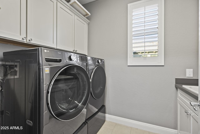 3770 E Ringtail Way, Phoenix, AZ 85050 - laundry room featuring washing machine and clothes dryer, cabinet space, and light tile patterned flooring