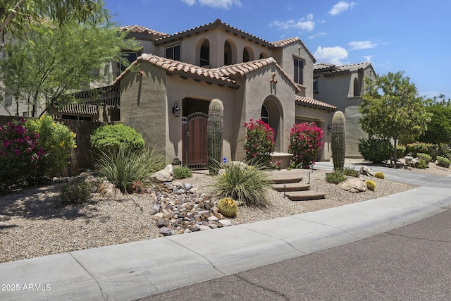 3770 E Ringtail Way, Phoenix, AZ 85050 - mediterranean / spanish-style home with stucco siding, an attached garage, and a tiled roof