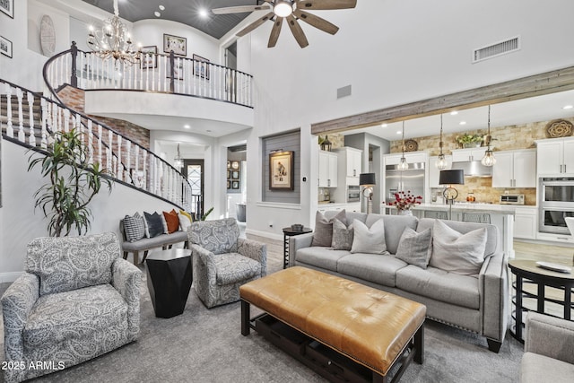 3770 E Ringtail Way, Phoenix, AZ 85050 - living area with stairway, a chandelier, a ceiling fan, a towering ceiling, and recessed lighting