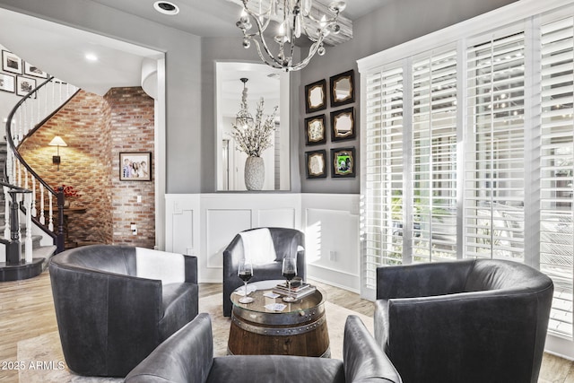 3770 E Ringtail Way, Phoenix, AZ 85050 - living area with stairway, brick wall, light wood-type flooring, and a chandelier