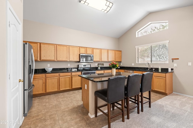 3488 N Lady Lake Ln, Casa Grande, AZ 85122 - kitchen with appliances with stainless steel finishes, high vaulted ceiling, a kitchen breakfast bar, a sink, and a kitchen island