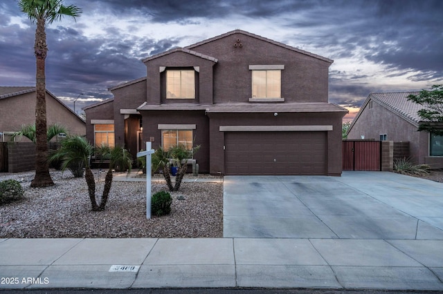 3488 N Lady Lake Ln, Casa Grande, AZ 85122 - traditional home with an attached garage, concrete driveway, stucco siding, fence, and a gate