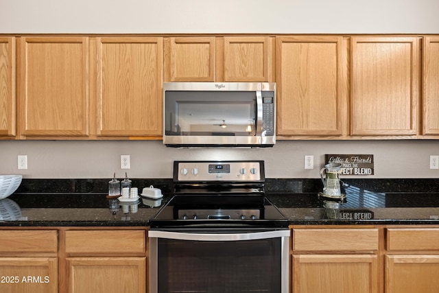 3488 N Lady Lake Ln, Casa Grande, AZ 85122 - kitchen with appliances with stainless steel finishes, dark stone counters, and light brown cabinetry