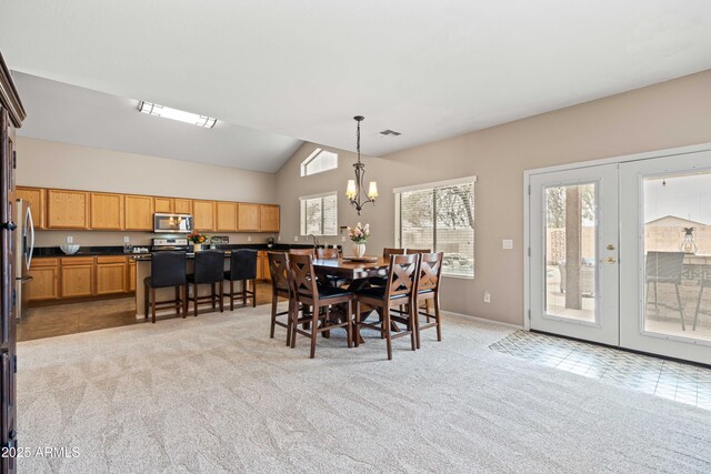 3488 N Lady Lake Ln, Casa Grande, AZ 85122 - dining space featuring light colored carpet, a chandelier, lofted ceiling, and french doors