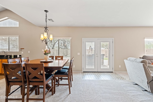 3488 N Lady Lake Ln, Casa Grande, AZ 85122 - dining room featuring french doors, light colored carpet, a chandelier, vaulted ceiling, and baseboards