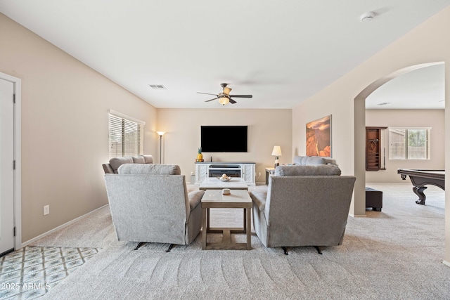 3488 N Lady Lake Ln, Casa Grande, AZ 85122 - carpeted living room with arched walkways and a ceiling fan