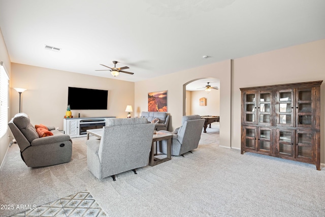 3488 N Lady Lake Ln, Casa Grande, AZ 85122 - carpeted living area featuring ceiling fan, arched walkways, and baseboards