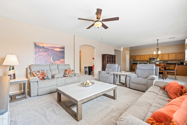 3488 N Lady Lake Ln, Casa Grande, AZ 85122 - living area featuring arched walkways, a ceiling fan, light colored carpet, and a chandelier