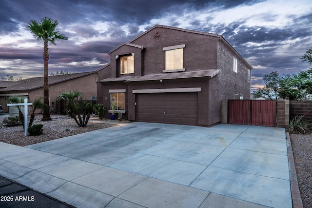 3488 N Lady Lake Ln, Casa Grande, AZ 85122 - traditional home featuring a gate, a garage, driveway, stucco siding, and fence