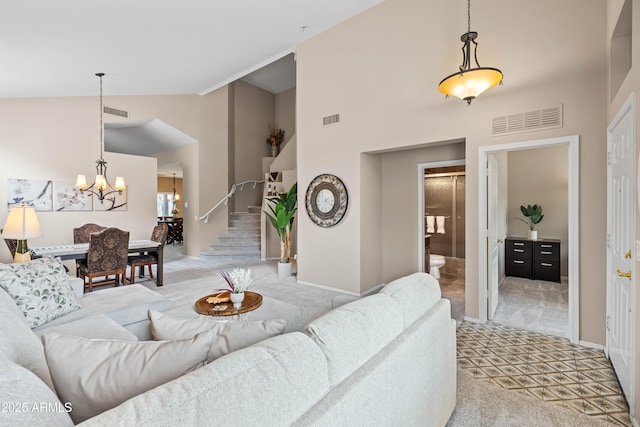 3488 N Lady Lake Ln, Casa Grande, AZ 85122 - living area featuring light carpet, high vaulted ceiling, a chandelier, baseboards, and stairway