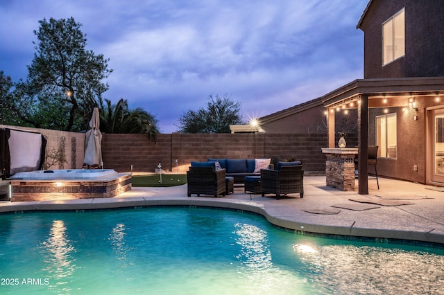 3488 N Lady Lake Ln, Casa Grande, AZ 85122 - pool at dusk featuring a hot tub, a fenced backyard, a patio, and outdoor lounge area