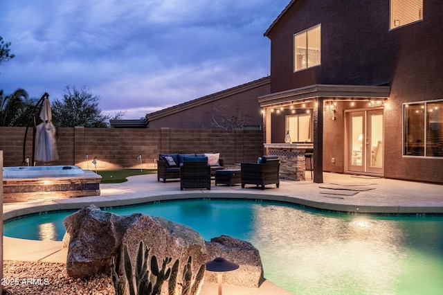 3488 N Lady Lake Ln, Casa Grande, AZ 85122 - view of swimming pool featuring an in-ground hot tub, fence, a patio area, exterior kitchen, and an outdoor living space