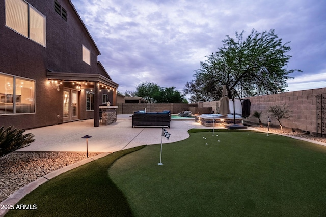 3488 N Lady Lake Ln, Casa Grande, AZ 85122 - fenced backyard with a putting green, a patio area, and a pool with connected hot tub