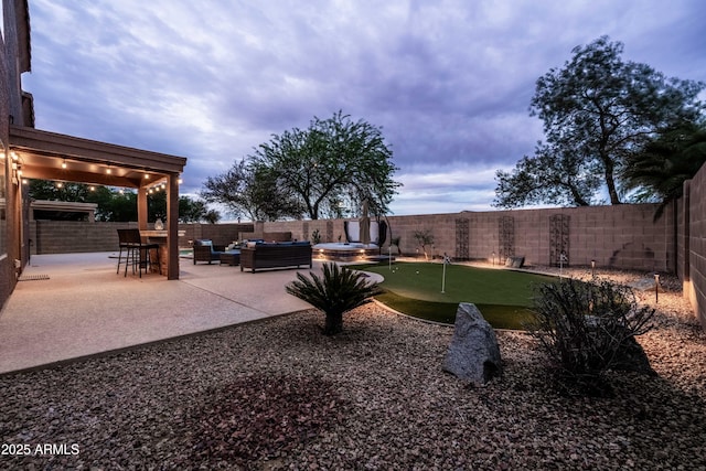 3488 N Lady Lake Ln, Casa Grande, AZ 85122 - fenced backyard with a putting green, outdoor lounge area, and a patio area