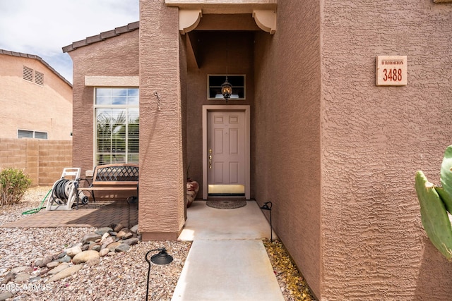 3488 N Lady Lake Ln, Casa Grande, AZ 85122 - doorway to property featuring fence and stucco siding