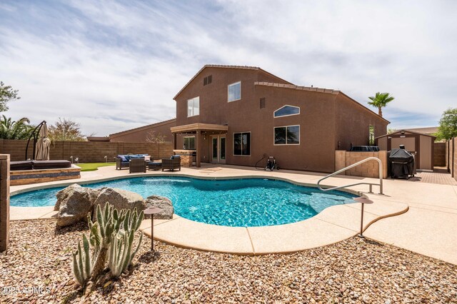 3488 N Lady Lake Ln, Casa Grande, AZ 85122 - view of pool with outdoor lounge area, a storage unit, a fenced backyard, area for grilling, and a patio