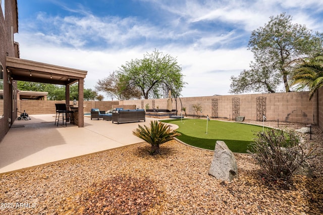 3488 N Lady Lake Ln, Casa Grande, AZ 85122 - fenced backyard featuring outdoor lounge area, an area to practice putting, and a patio area