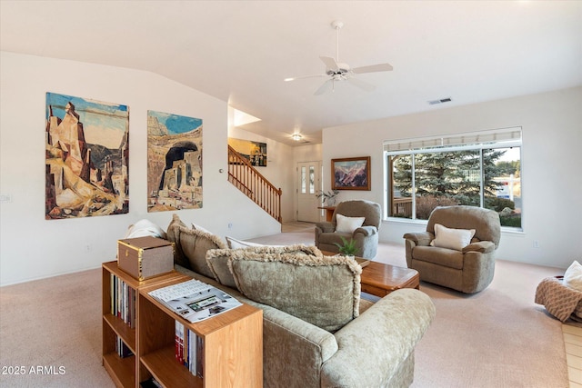 living room featuring light colored carpet, vaulted ceiling, and ceiling fan