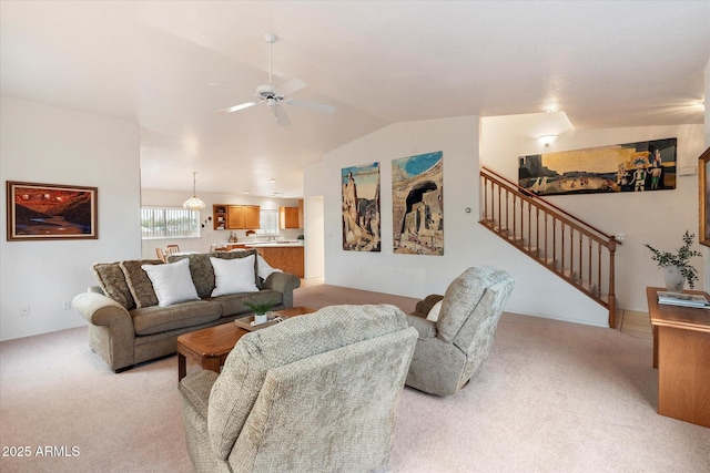 carpeted living room with vaulted ceiling and ceiling fan