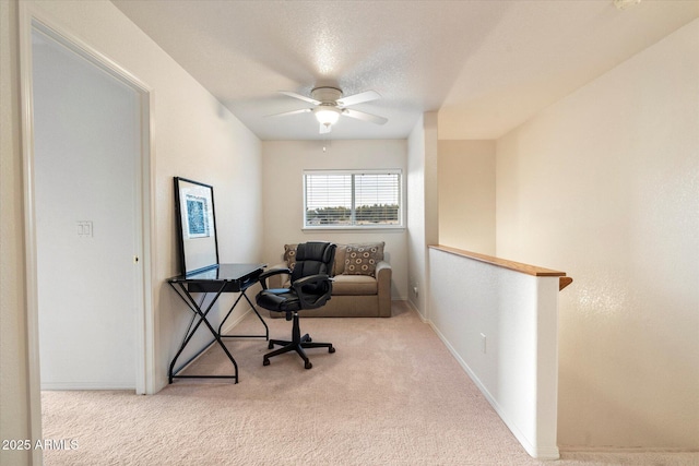 carpeted office with ceiling fan and a textured ceiling