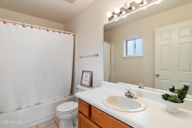 full bathroom featuring vanity, tile patterned flooring, toilet, shower / bath combo with shower curtain, and a textured ceiling