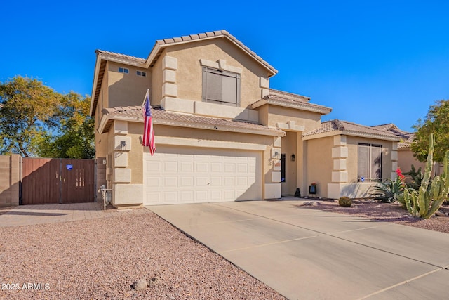 mediterranean / spanish-style home featuring a gate, concrete driveway, a tile roof, and stucco siding