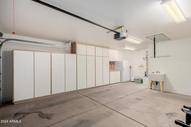 garage with sink, a garage door opener, and white refrigerator