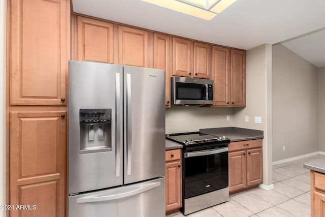 kitchen with light tile patterned floors and appliances with stainless steel finishes