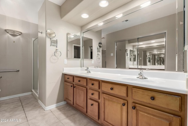 bathroom featuring walk in shower, vanity, and tile patterned flooring