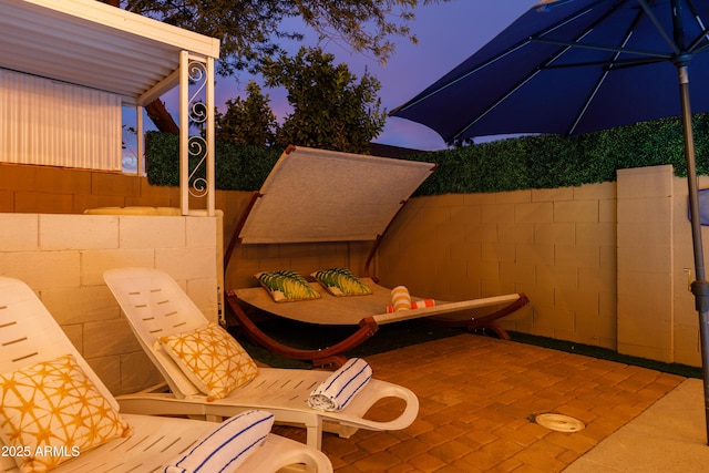 view of patio terrace at dusk