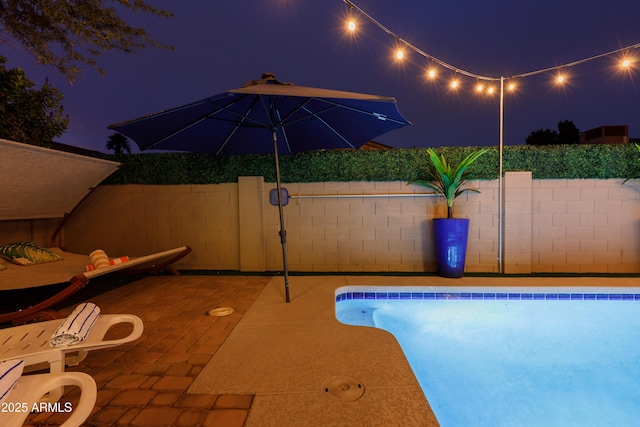 view of pool at night